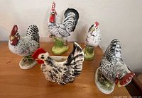 Group shot of all five ceramic roosters showing variety and condition