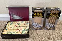 Overall lot showing two boxed rack sets and open domino case with tiles