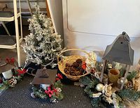 Group shot showing two lanterns, mini tree and basket of pinecones