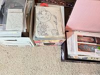 Three boxes side by side containing stacks of pattern sheets