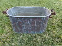 Front view of copper boiler showing patina and handles