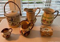 Group shot of all six ceramic lusterware items