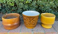 Front view of three Haeger planters showing forms, glazes and overall condition