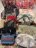 Group shot showing all eleven quilted handbags and totes