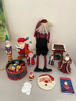 Group view of all Santa figurines, ornaments and drum container