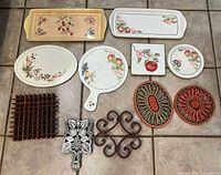 Group shot showing all eleven serving trays and trivets