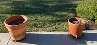 Both terracotta planters on patio