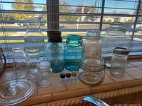 Group shot of all jars, carafe, bottles and vials on windowsill
