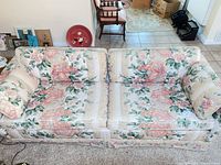 Front view of floral sofa with cushions and pillows