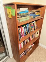 Front angled view showing entire bookshelf with books on shelves