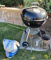 Entire grill with accessories including charcoal bag, chimney starter and brush