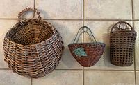 Three wicker hanging baskets side by side