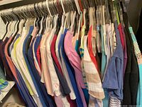 Rack of assorted women’s tops showing quantity and variety