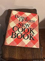 Front cover of Better Homes and Gardens New Cook Book on wooden stand