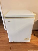 Front view of white Danby chest freezer showing exterior and control knob
