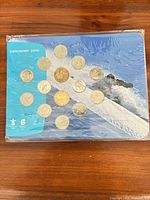 Front of sealed Vancouver 2010 coin collection showing 17 coins and snowboarder image