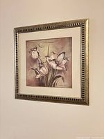 front view of framed floral print hanging on wall