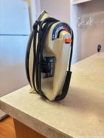 Side view of Black & Decker steam iron with cord wrapped