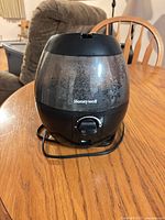 Front view of Honeywell tabletop humidifier on wooden table