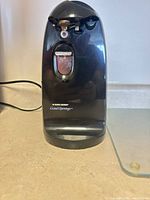 Front view of Black+Decker Grand Openings electric can opener showing logo and plug