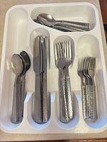 Tray with matching stainless cutlery, teaspoons, tablespoons, forks, knives in white insert