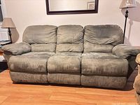 Front view of olive green three-seat sofa