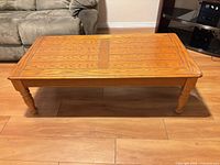 Full view of rectangular solid wood coffee table on hardwood floor