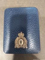 Blue textured presentation case with metal RCMP crest