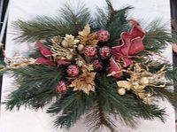 Top view showing full centerpiece with greenery, ribbons, ornaments and gold accents