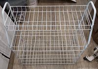 front view of entire four-shelf white metal wire shoe rack