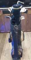 Bag with woods and headcovers visible
