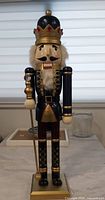 Front view of 24-inch wooden nutcracker king on base