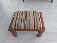 Ottoman top view showing cushion pattern and wooden frame
