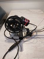 Base unit showing spool, motor, power cord and mount