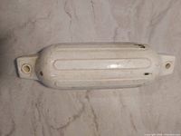 White boat fender top view showing eyelets and scuffs
