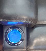 Close-up of LED-lit cupholder on armrest