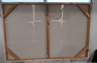 Back of stretched canvas showing wooden stretcher bars and open gallery wrap