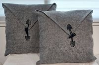 Front view of both gray heathered pillows showing envelope flaps and toggle button closures