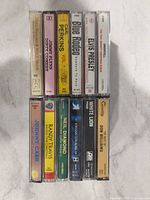 Spines of 12 cassette cases stacked two columns
