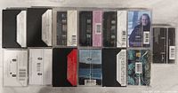 All cassette cases rear sides showing barcodes and track listings