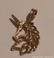 Gold tone unicorn head pendant with bail loop