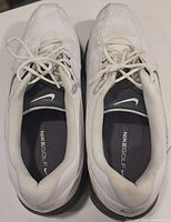 Top view of both shoes showing lace-up closure, padded collars, NikeGolf insoles