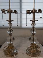 Front view of both matching glass and chrome table lamps with cords
