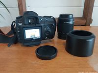 Back view of Sony a200 body, telephoto lens, lens hood, front cap