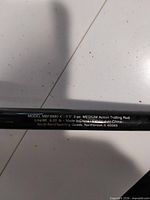 Close-up showing printed model information and specifications on rod blank