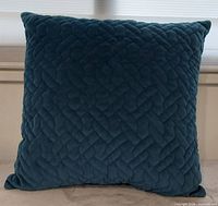 Front view of teal quilted velvet pillow