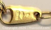 Hallmarked tag near clasp showing stamp