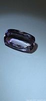 Oblique top view of faceted elongated cushion amethyst showing overall shape and clarity