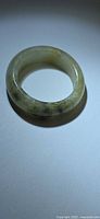 Full view of jade band ring showing color and translucency