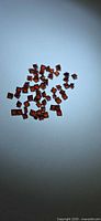 Cluster of square orange-red garnets on light background
